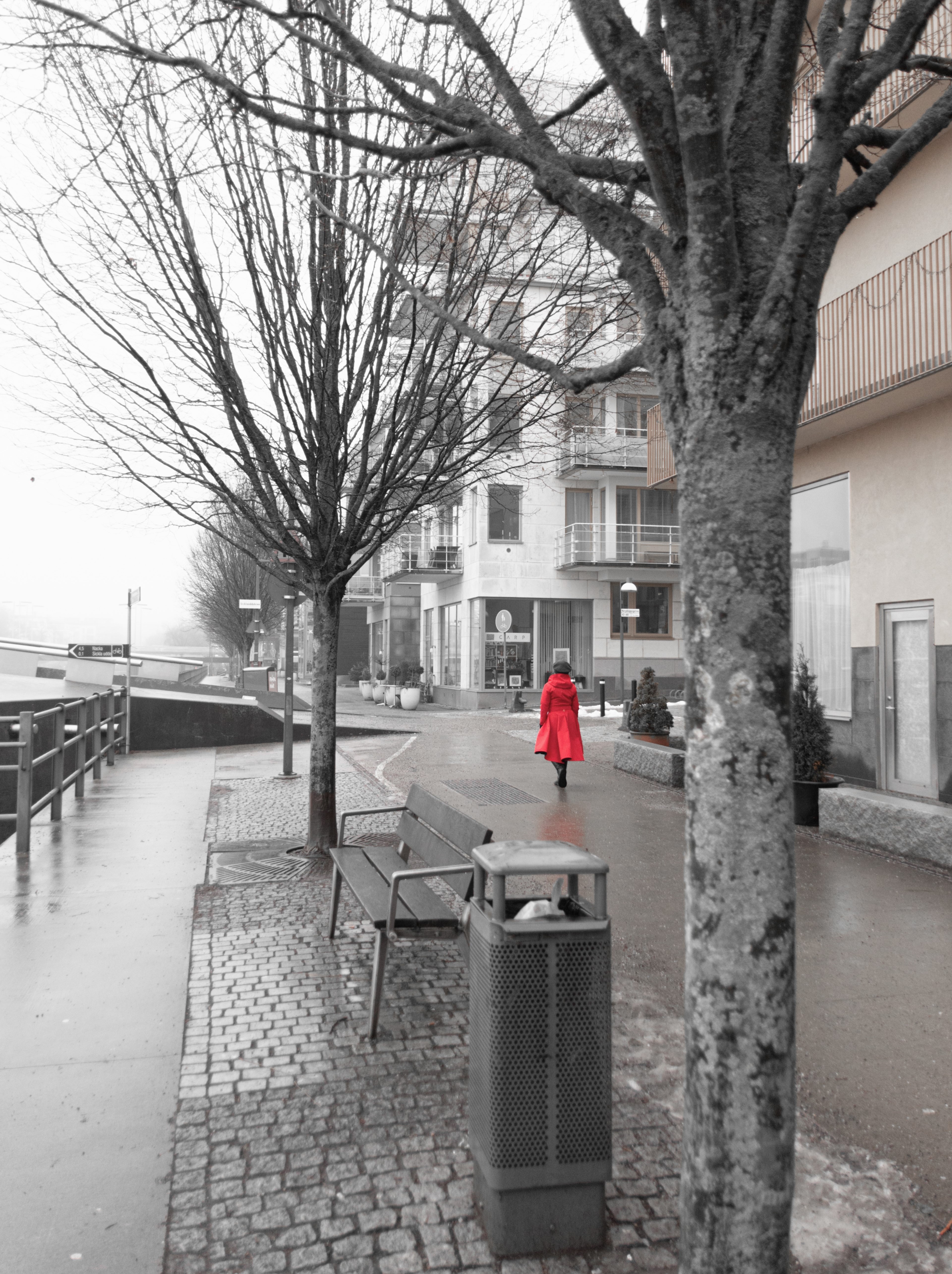 Red coat stands out among the city